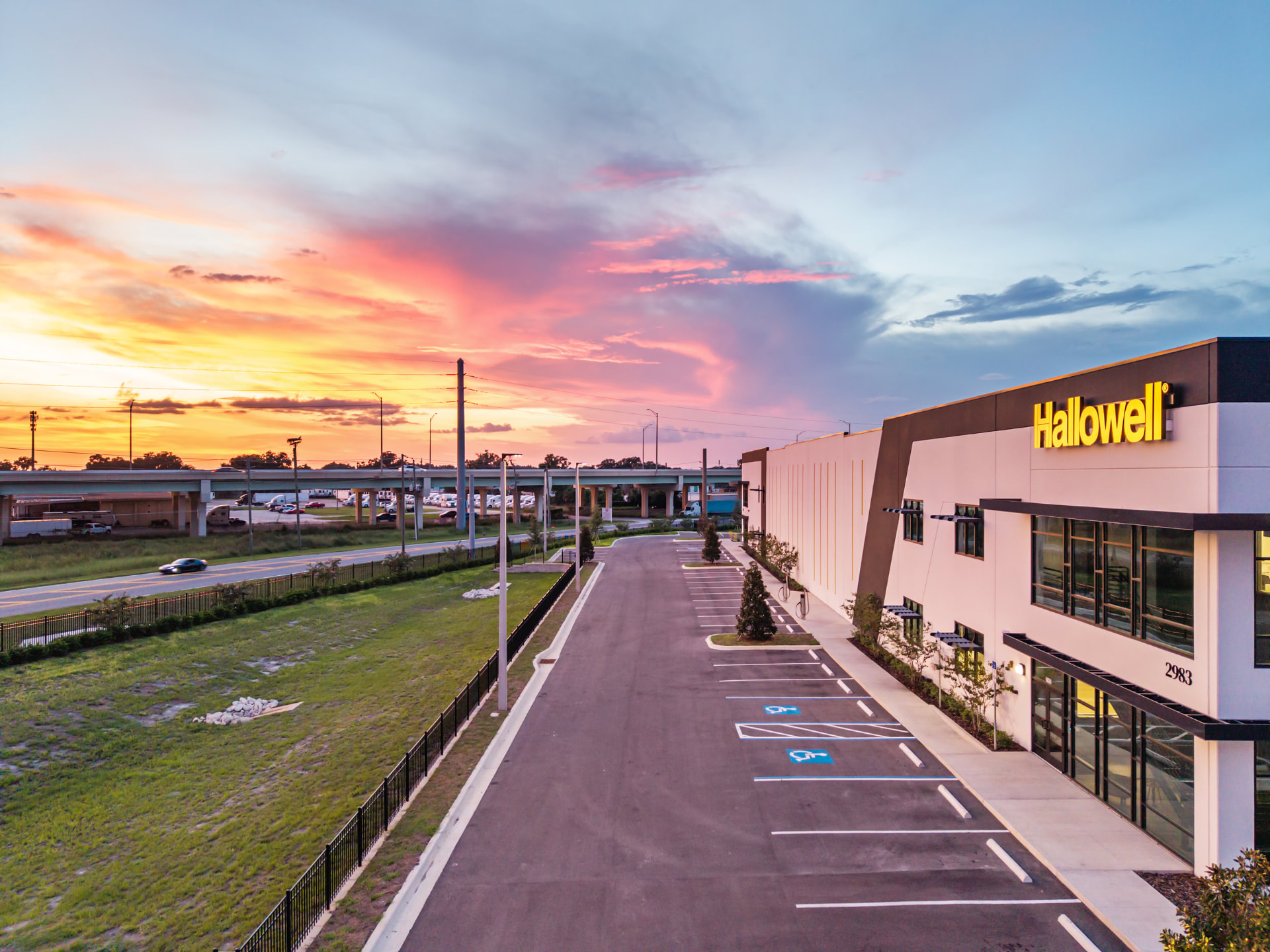 Hallowell facility facade at dusk with illuminated signage, aerial photography by IRL Marketing